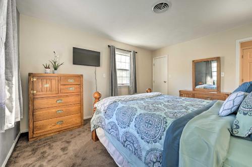a bedroom with a bed and a dresser and a tv at Hedge House Just 4 miles to Notre Dame! in Granger