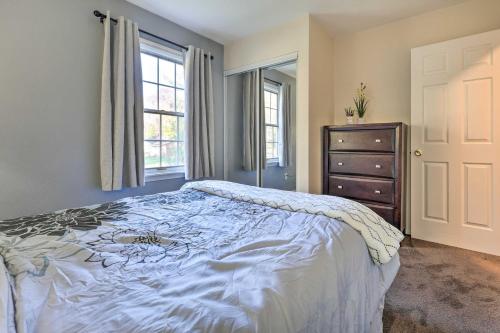 a bedroom with a bed and a dresser and a window at Hedge House Just 4 miles to Notre Dame! in Granger