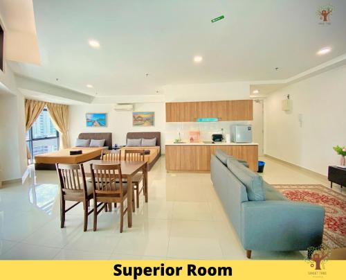 a living room with a blue couch and a table at Sweet Tree Homestay Petaling Jaya in Petaling Jaya
