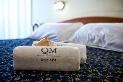 a hotel room with two towels on a bed at Hotel Queen Mary in Cattolica