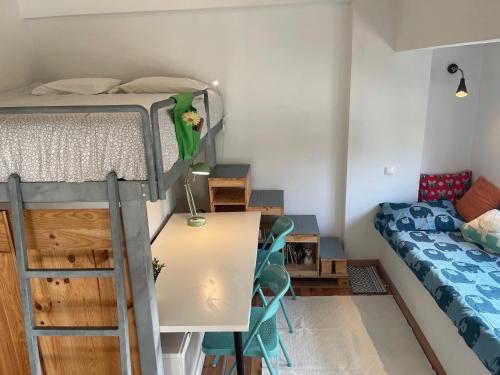 um dormitório com uma cama, uma mesa e cadeiras em BestHomeStay- Parede Beach (Lisbon) em Parede