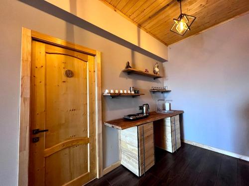 a room with a counter and a wooden door at Sargsyan ECO house in Sevan