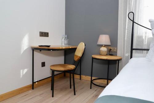 a bedroom with a desk and a chair and a bed at Sargsyan ECO house in Sevan
