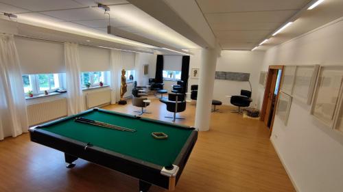 an office with a pool table in the middle of a room at Ferienwohnungen Kricklsäge in Philippsreut