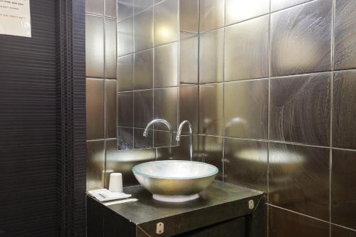 a bathroom with a bowl sink on a counter at Laria Hotel in Suwon