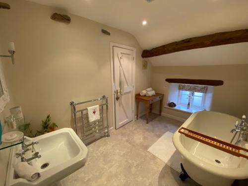 a bathroom with a white sink and a toilet at Boxtree in Penrith