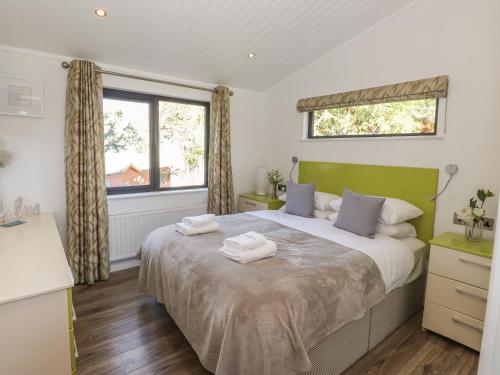 a bedroom with a bed with two towels on it at Windermere Lodge in Bowness-on-Windermere
