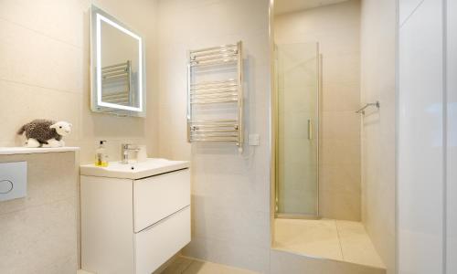 uma casa de banho branca com um lavatório e um chuveiro em High Pike em Ambleside