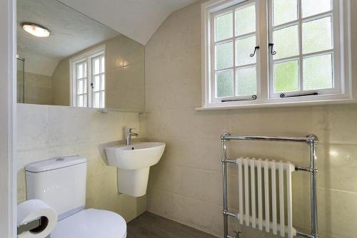 a bathroom with a toilet and a sink at Acorn Cottage in Grasmere