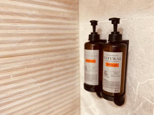 two bottles of essential oils hanging on a wall at Housingleón - Palacio de Don Ramiro in León