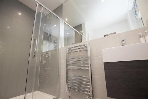 a bathroom with a shower with a glass door at Silver Howe in Grasmere