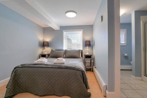 a bedroom with a bed with two towels on it at 2BR Apt w/ 3 min Walk to downtown SWH - [Low Tide] in Southwest Harbor
