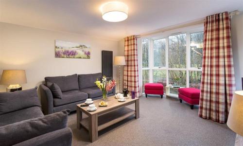 a living room with a couch and a table at Riverville in Grasmere