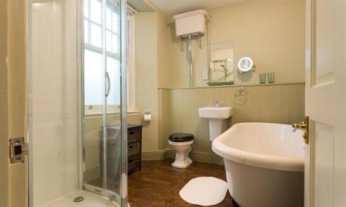 a bathroom with a shower and a sink and a toilet at Orrest Range in Windermere