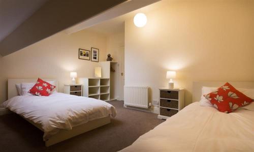 1 dormitorio con 2 camas y 2 mesitas de noche en Orrest Range, en Windermere