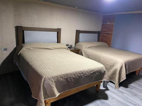 a room with two beds in a room at KALOM in Creel