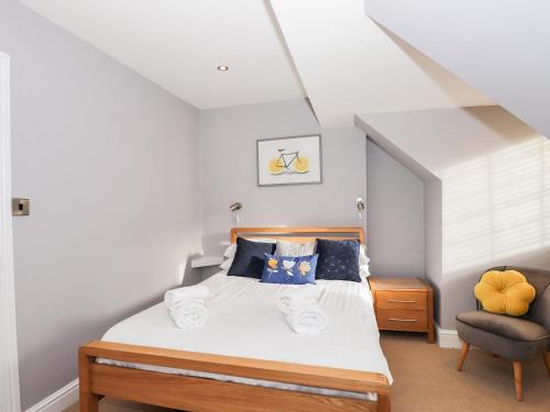 ein Schlafzimmer mit einem Bett und einem Stuhl in der Unterkunft Lakestone Cottage in Windermere
