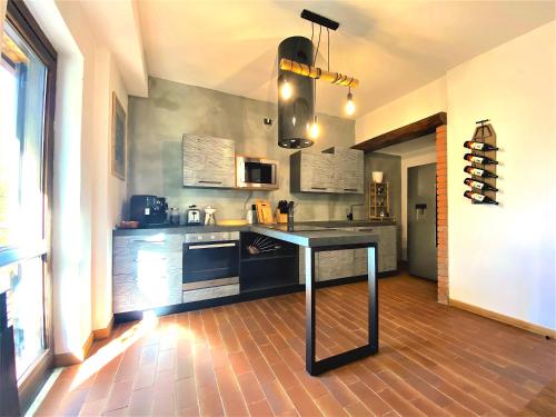 a kitchen with a table in the middle of it at Chalet Bornhome relax, sport e cultura altopiano del sole 6 ospiti - pet Frendly in Borno