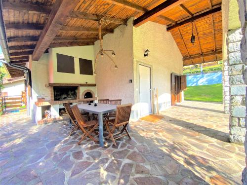 a patio with a table and chairs and a fireplace at Chalet Bornhome CIR O17022 in Borno