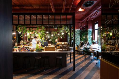 a restaurant with a bar with people sitting at tables at Hotel Indigo Brussels - City by IHG in Brussels