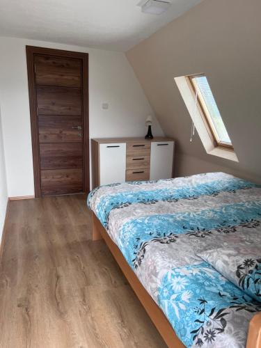 a bedroom with two beds and a wooden floor at Mavrovo Square " Villas & Apartment " in Mavrovo