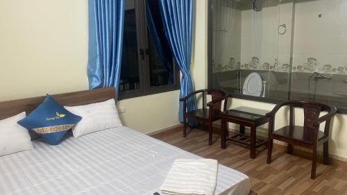 a bedroom with a bed and a table and a mirror at Nhà Nghỉ Hương Trà 2 Tân Phú 