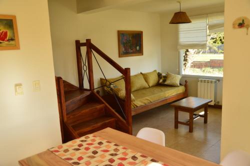 a living room with a couch and a table at Valle del Molino in Trevelin