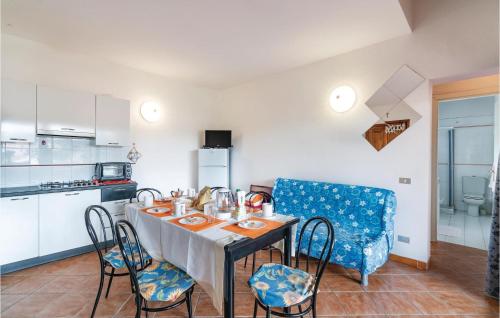 a kitchen and dining room with a table and chairs at Trilo Sup in Trinità d'Agultu e Vignola