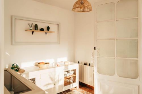 a bathroom with white walls and a white door at ~Villa El Riu del Cel~Increíbles vistas al mar in Lloret de Mar
