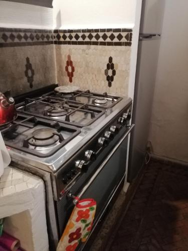 a stove top oven sitting in a kitchen at Charmant riad pour familles ou groupes - Dar Mama in Essaouira
