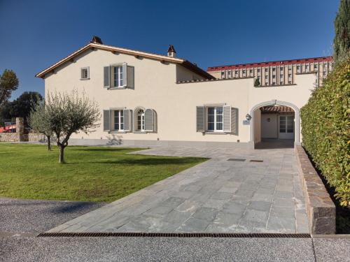 a large white house with a driveway at Villa Carobbi Apartments Florence in Florence