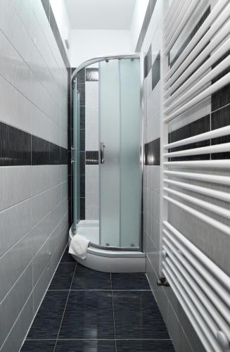 a bathroom with a shower and a bath tub at Virtus Apartments and Rooms with Free Private Parking in Zagreb