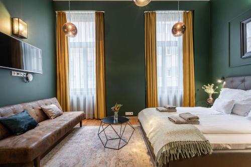 a living room with a bed and a couch at The Pearl of the Heart of Budapest in Budapest