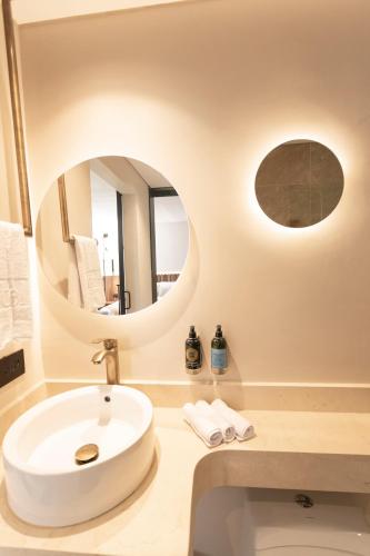 a bathroom with a white sink and a mirror at 1616 Hotel in Medellín