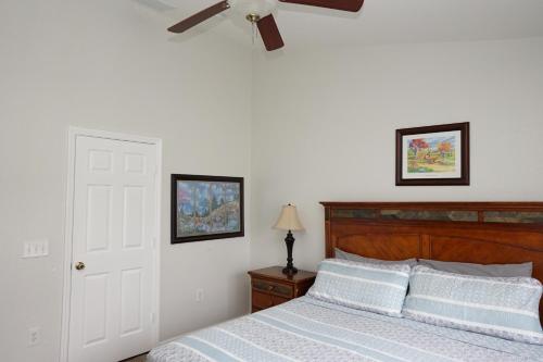 a bedroom with a bed with a ceiling fan at Windsor Hills Resort- 7682 Sir Kaufmann in Orlando