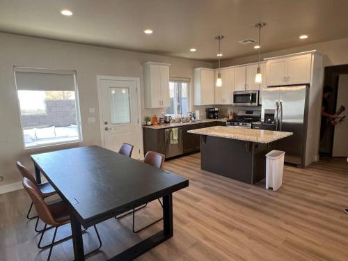 a large kitchen with a table and chairs in it at Water Canyon 4bd3Bath HotTubDeck in Hildale