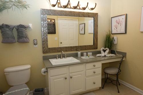 a bathroom with a sink and a mirror at Windsor Hills Resort- 405 in Orlando