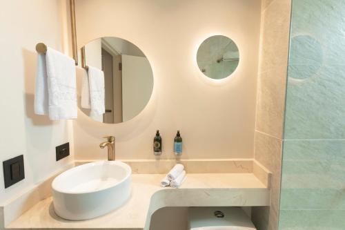a bathroom with a sink and a mirror at 1616 Hotel in Medellín