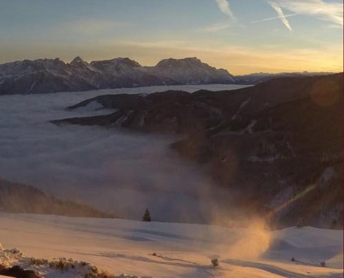 a view of a foggy valley with mountains in the background at Pöchtlhof in Leogang
