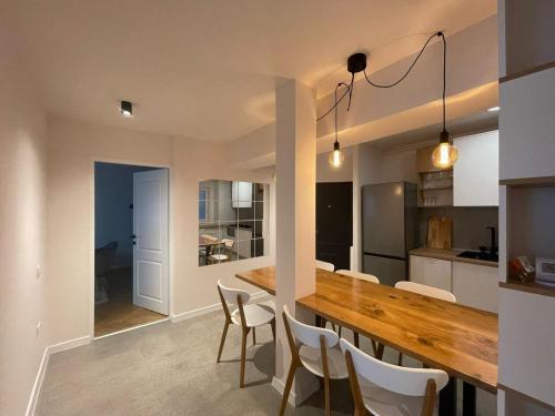 a kitchen and dining room with a wooden table and chairs at Apartament Mony in Timişoara