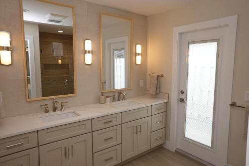 a bathroom with two sinks and a large mirror at 213 Grant Ave in Cocoa Beach