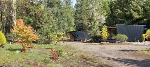 a cabin in the middle of a forest at Cabañas Los Volcanes Ensenada Puerto Varas in Ensenada