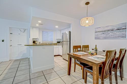 a kitchen and dining room with a table and chairs at Twins Inn & Apartments in St Pete Beach