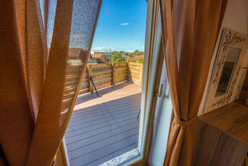a sliding glass door to a balcony with a view at Apartments Galunder in Veržej