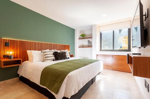 a bedroom with a large bed and a window at The Corner Condesa in Mexico City