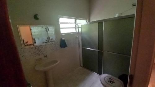 a bathroom with a shower and a sink at Residência Manto Azul in Aparecida