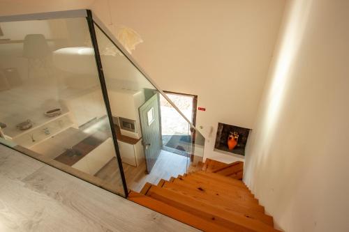 a staircase in a house with a glass wall at Azores Country Nature in Lagoa