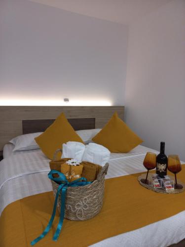 a bed with a basket of towels and a bottle of wine at Touch the Sky in Moieciu de Jos