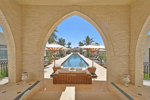 an archway leading to a pool at a resort at DAR OOMI in Zarzis