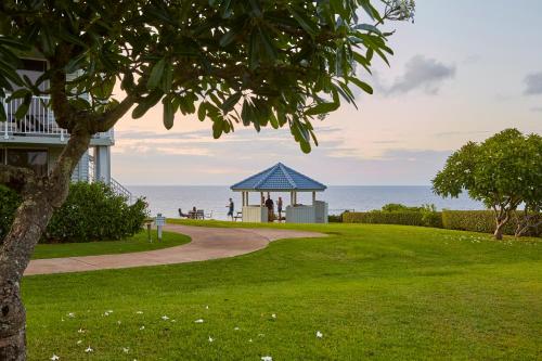 a gazebo on the beach next to the ocean at The Cliffs at Princeville in Princeville